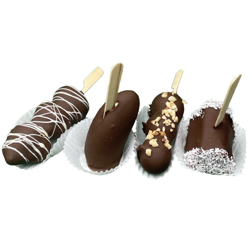 Schokofrüchte – frisches Obst in feinster Schokolade getunkt. Sorten: Banane, Ananas, Erdbeeren und Trauben. Je nach Saison können auch andere Früchte verwendet werden. Beliebtes Fingerfood für Catering, Büro-Meetings oder als Dessert